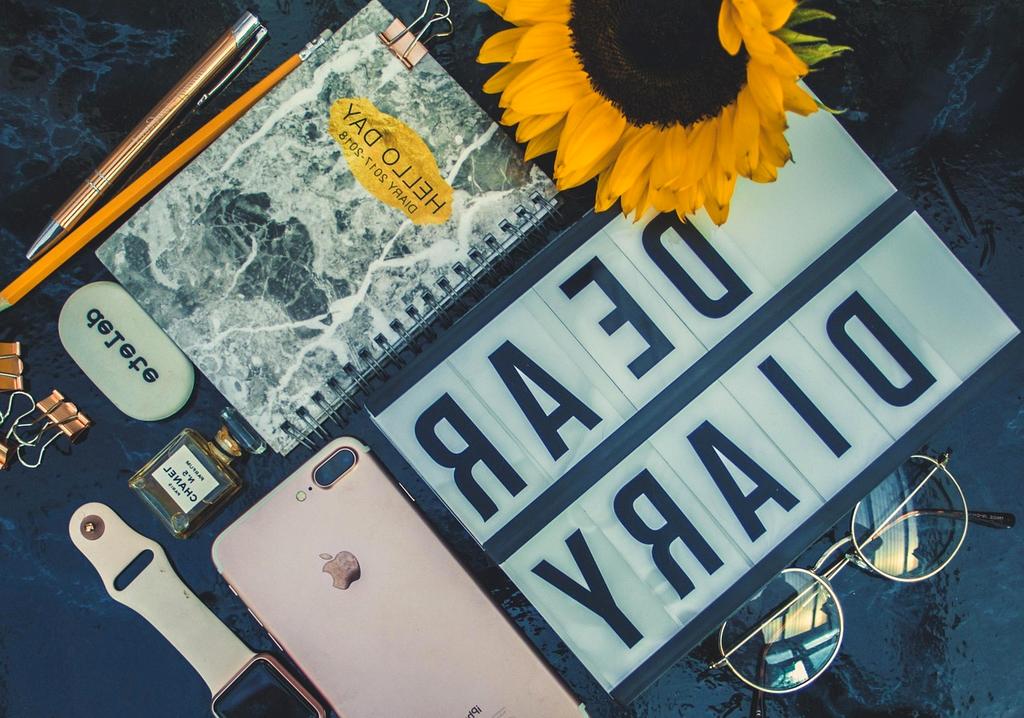 Organized workspace with planner, calendar, and digital apps open on screen