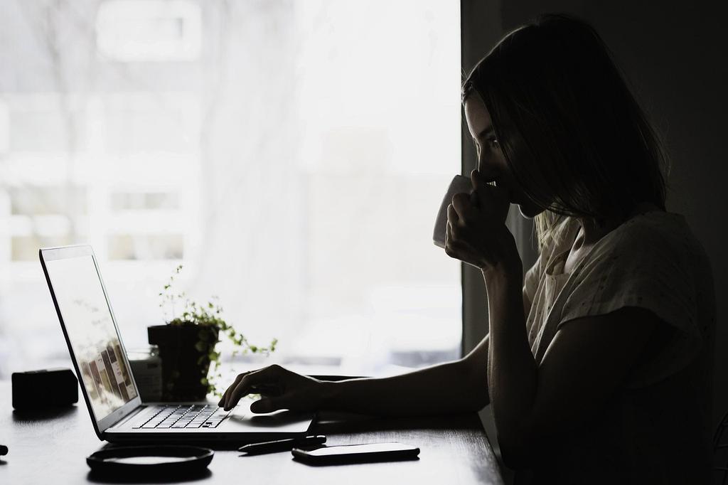 Person organizing their life with digital planning tools and goal-setting materials